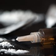 Close up of drug syringe and cooked heroin