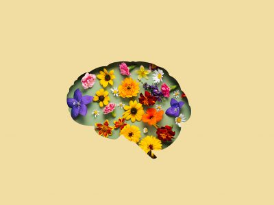 Paper cut brain symbol and flowers on yellow background