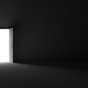 Grayscale shot of an open door letting light into a dark room
